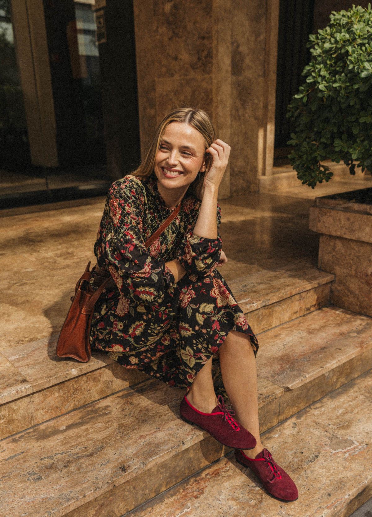 Theodora dress, relaxed look seated with burgundy shoes | Cherubina